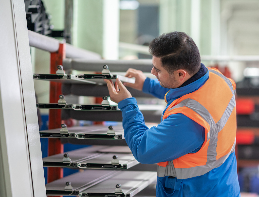 Person quality controlling metal parts