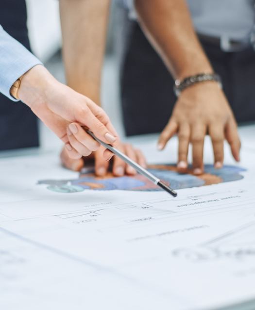 People pointing at a blueprint
